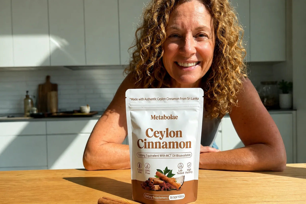 Smiling woman at her kitchen table with a bag of Metabolae Ceylon Cinnamon